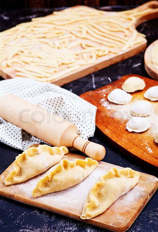 Raw flour products on the black table, stock photo