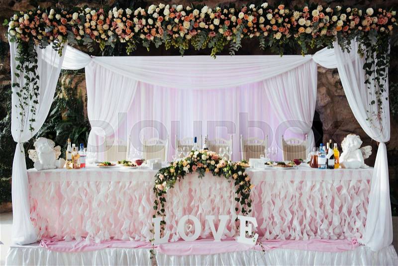 Luxurious decorated table in the main hall wedding, stock photo