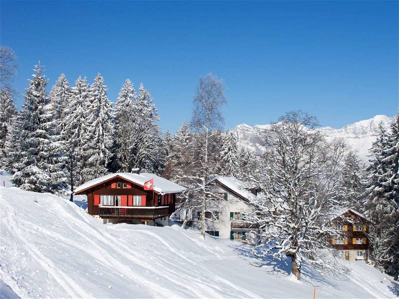 Winter holiday house in swiss alps, stock photo