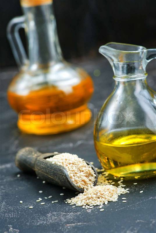 Sesame oil in bottle and on a table, stock photo