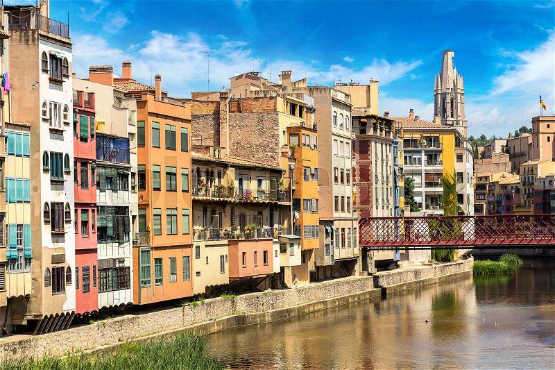 Colorful houses and Eiffel bridge in Girona, in a beautiful summer day, Catalonia, Spain, stock photo