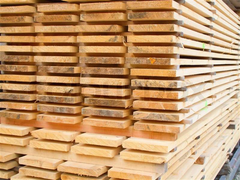 Stack of new wooden studs at a lumber yard, stock photo