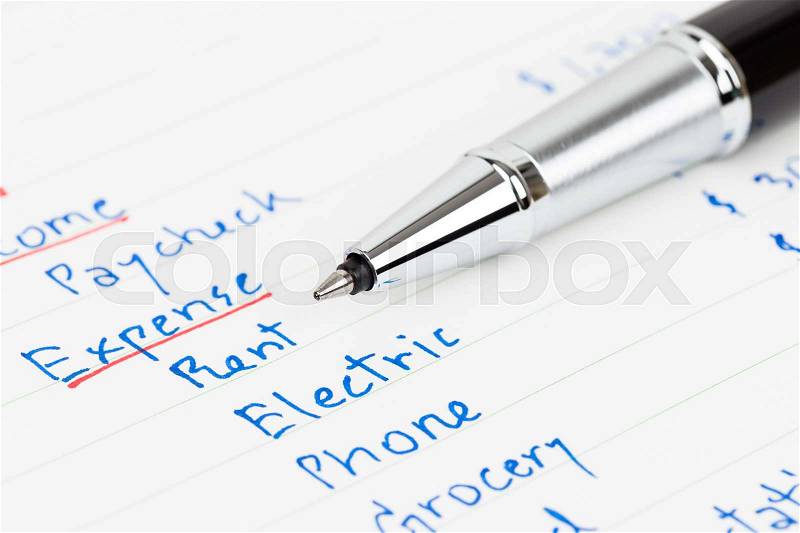 Hand writing home budget with calculator, stock photo