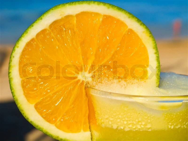 Orange cocktail on the beach, stock photo