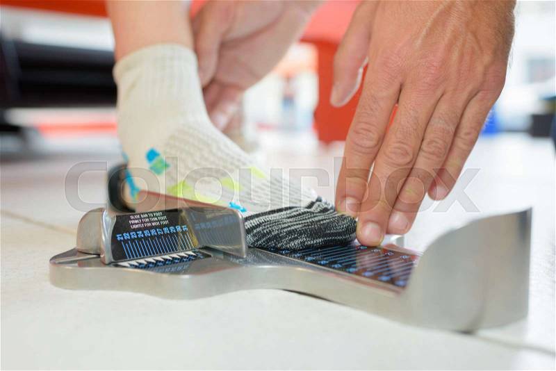 Child's foot being measured for shoes, stock photo