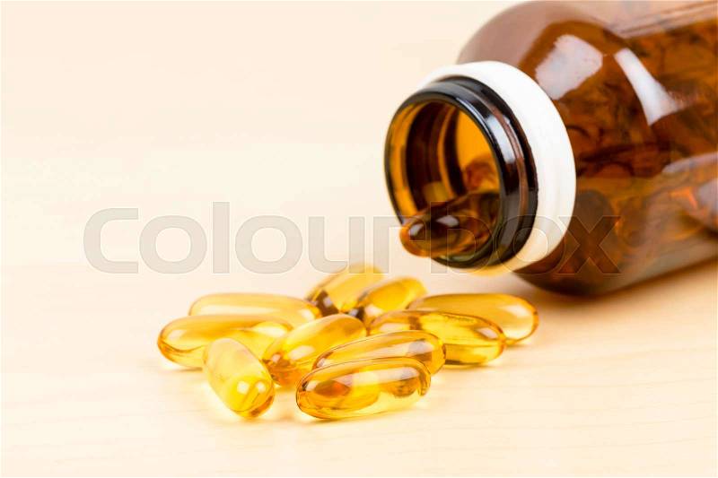 Fish oil capsule food supplement with bottle, stock photo