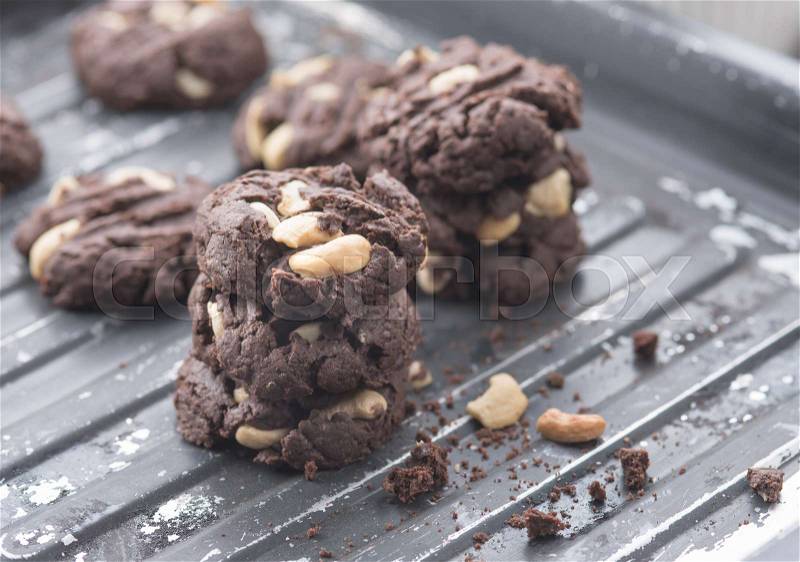 Delicious chocolate cookies with nuts on a baking tray , stock photo