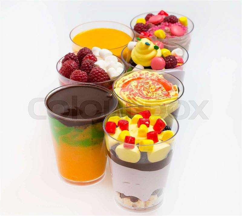 Mini desserts and meat canapes vegetable snacks in plastic cups canapes, stock photo