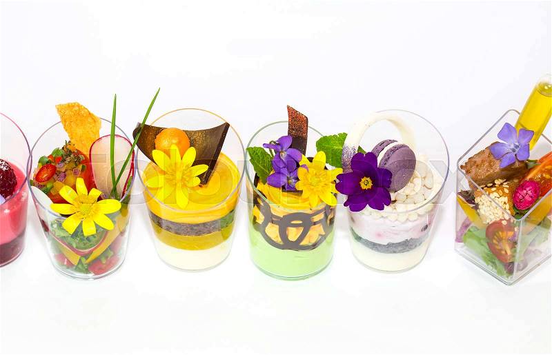 Mini desserts and meat canapes vegetable snacks in plastic cups canapes, stock photo