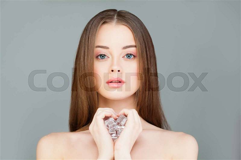 Young Healthy Woman with Ice Cubes. Beautiful Model Girl, Spa and Skin Care Concept, stock photo