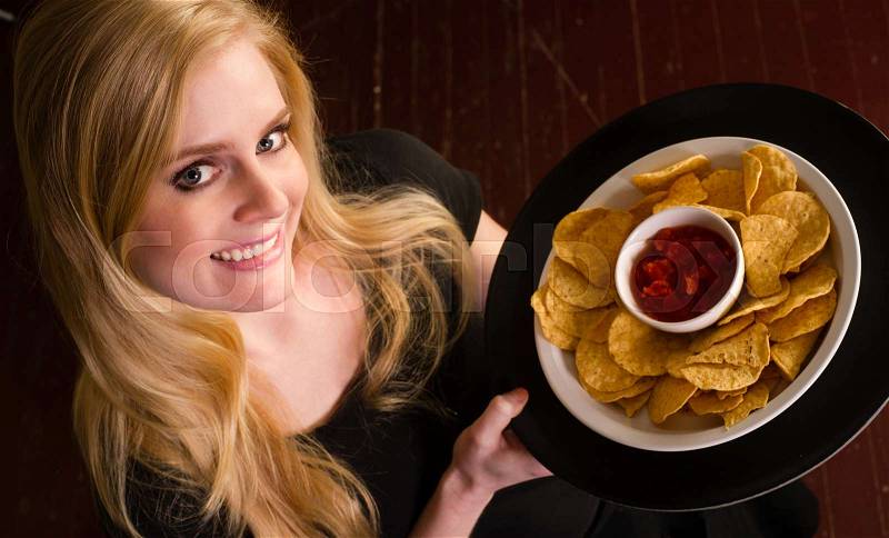 Young Attractive Female Server Brings Appetizer Chips Salsa Food Tray, stock photo