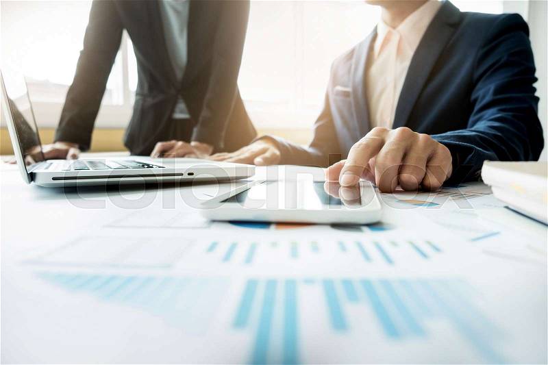 Business adviser analyzing financial figures denoting the progress in the work of the company, stock photo