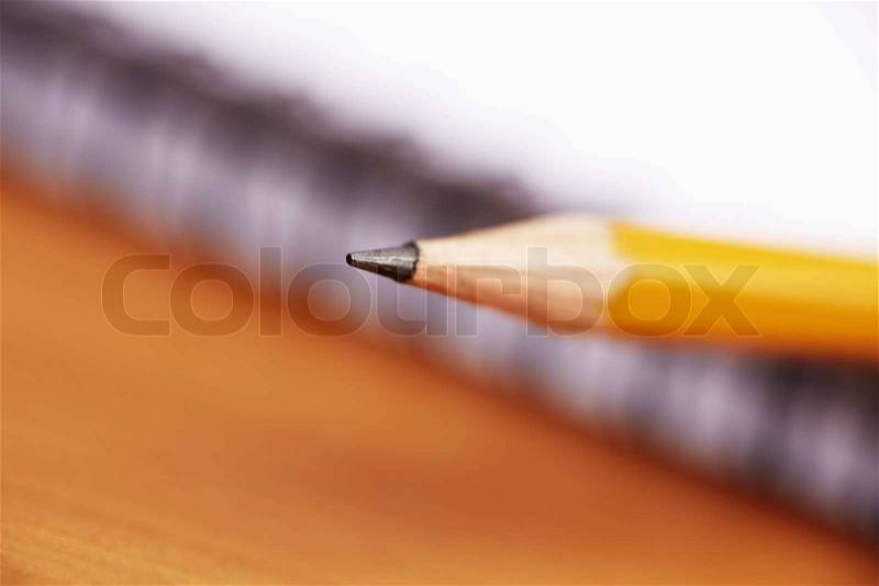 Yellow pencil, selective focus on writing part (center of photo), stock photo