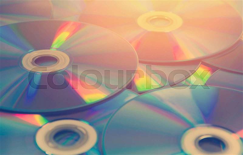 Colorful compact discs, set of DVD scattered on a table, stock photo