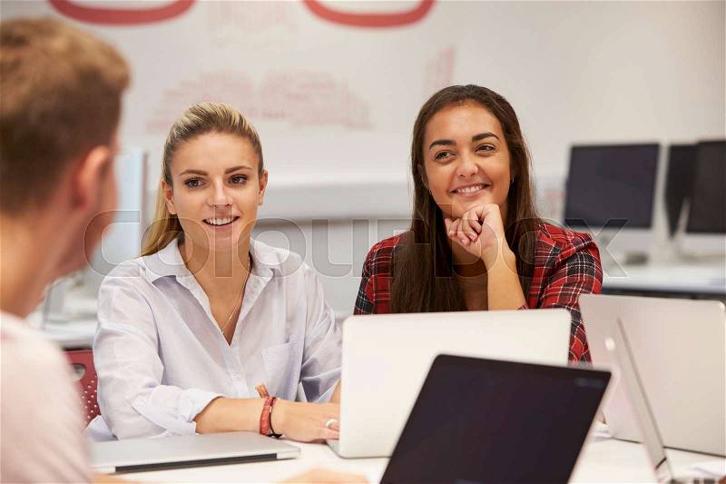 Female University Students Collaborating On Project, stock photo