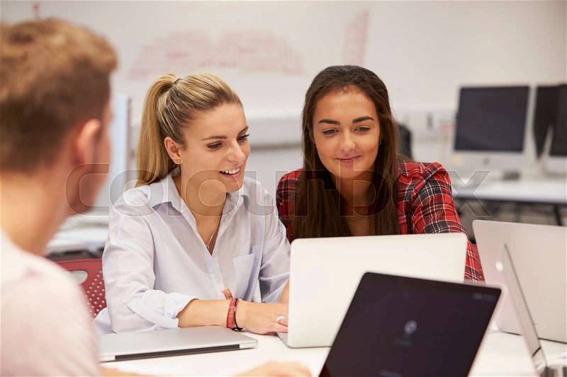 Female University Students Collaborating On Project, stock photo