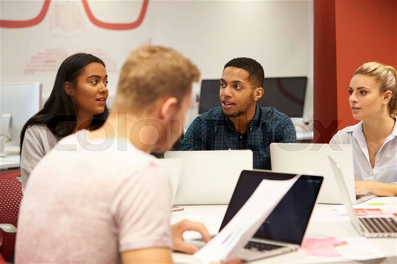 Group Of University Students Collaborating On Project, stock photo