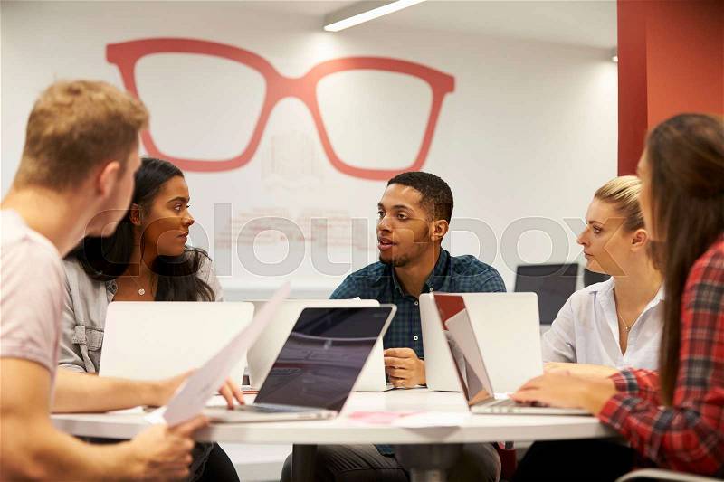 Group Of University Students Collaborating On Project, stock photo