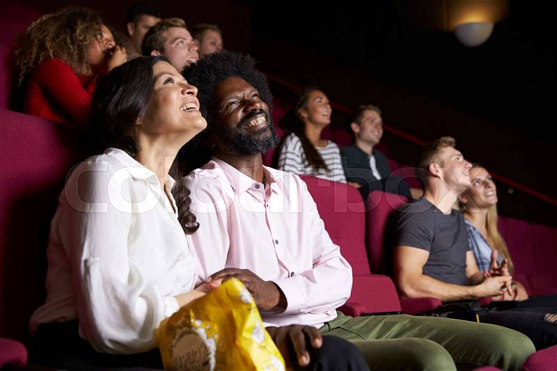 Couple In Cinema Watching Comedy Film, stock photo