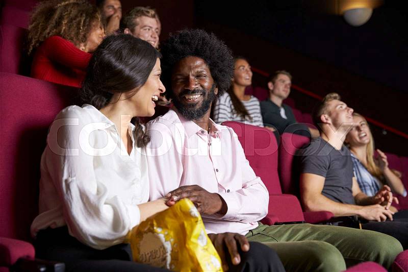 Couple In Cinema Watching Comedy Film, stock photo