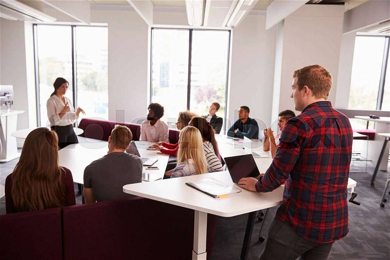Group Of University Students Attending Lecture On Campus, stock photo