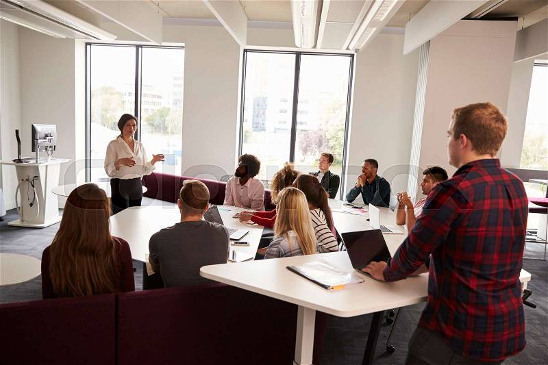 Group Of University Students Attending Lecture On Campus, stock photo