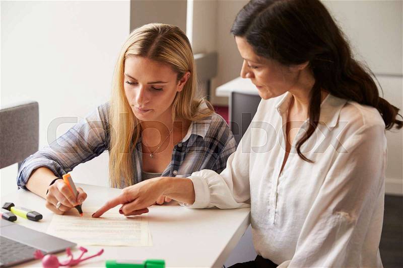 Tutor Using Learning Aids To Help Student With Dyslexia, stock photo