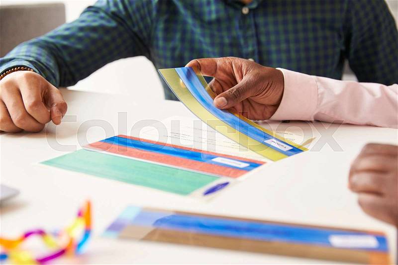 Close Up Of Student With Dyslexia Using Colored Overlays, stock photo