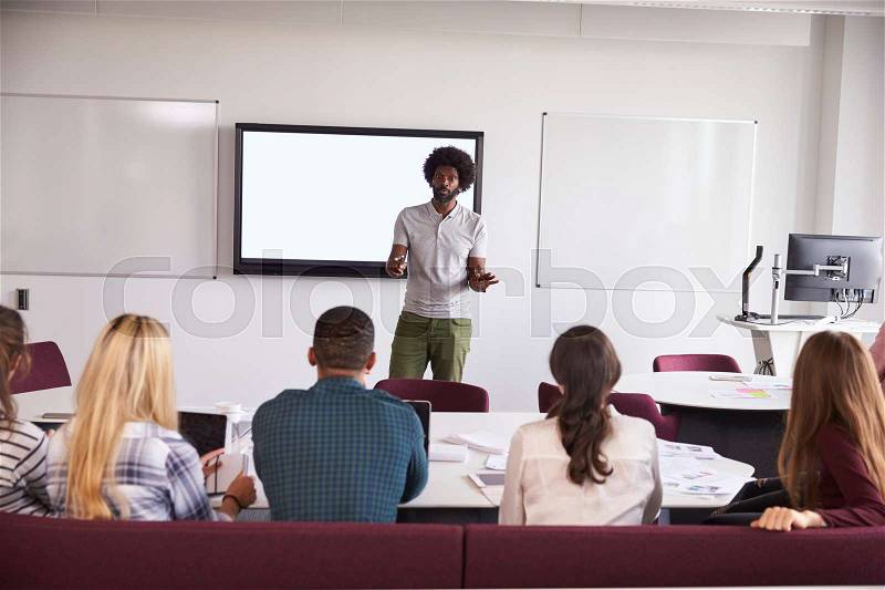 University Students Attending Lecture On Campus, stock photo
