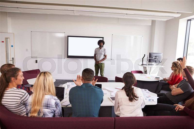 University Students Attending Lecture On Campus, stock photo
