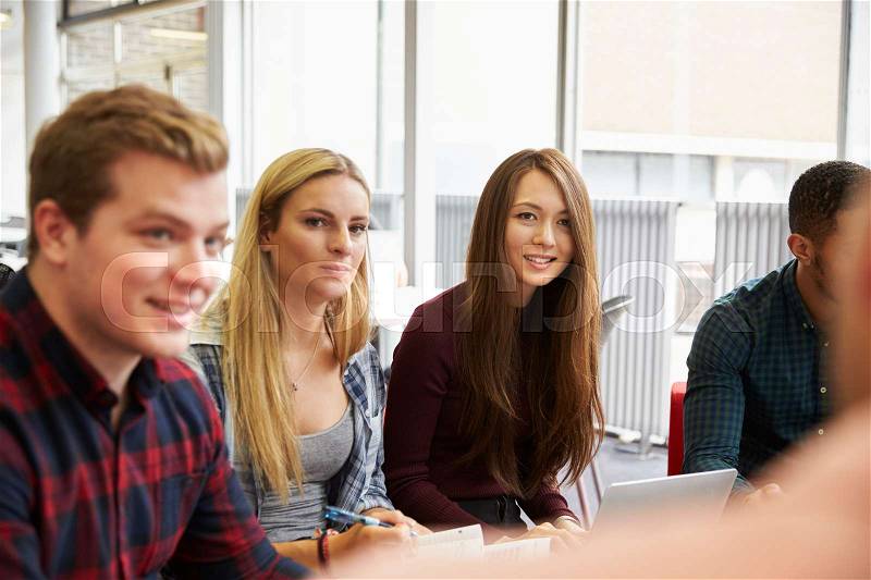 Group Of Students In Library Collaborating On Project, stock photo