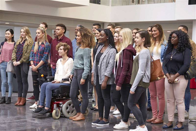 Student group standing in university atrium looking away, stock photo