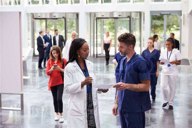 Staff In Busy Lobby Area Of Modern Hospital, stock photo