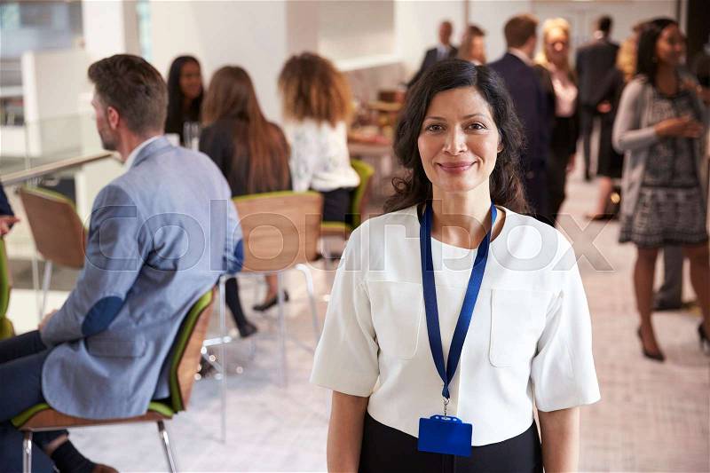 Portrait Of Female Delegate During Break At Conference, stock photo