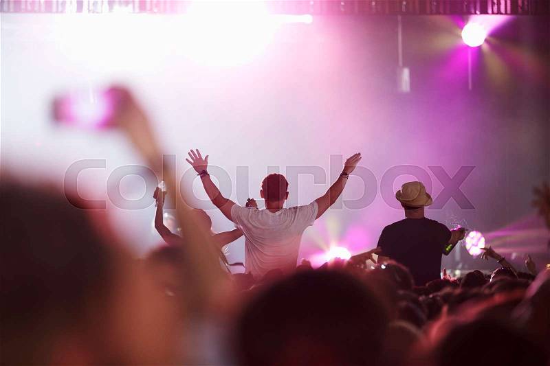 Fans Sitting On Friend\'s Shoulders At Music Festival, stock photo