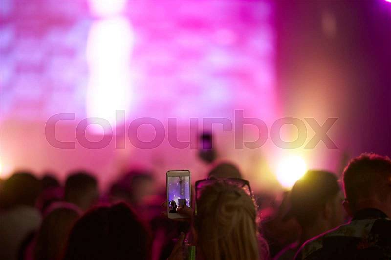 Fan Taking Photo On Mobile Phone At Music Festival, stock photo