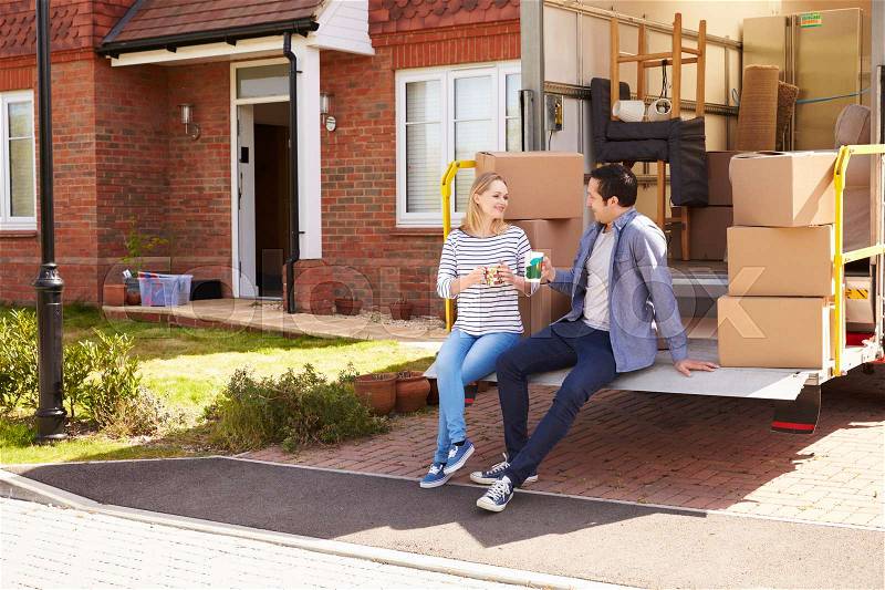 Couple On Tail Lift Of Removal Truck Moving Home, stock photo