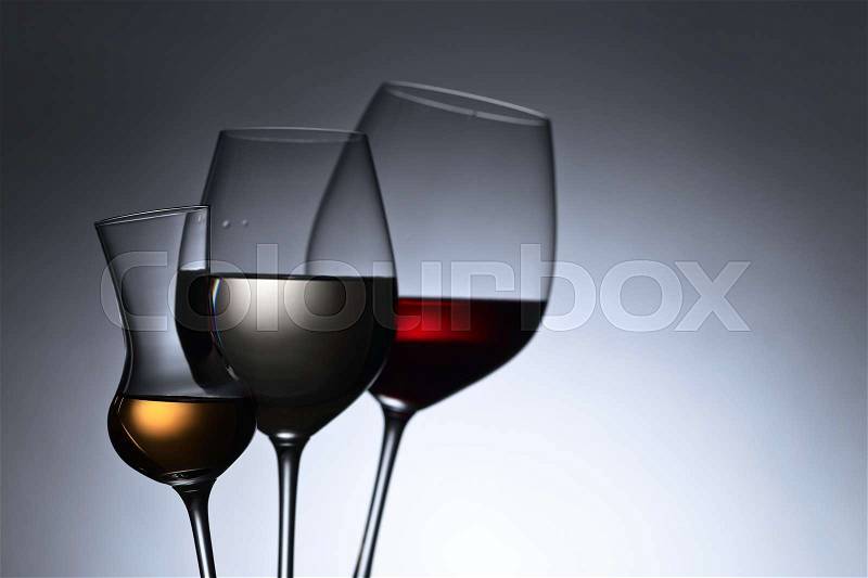 Closeup of glasses with red and white wine, free space for your text, stock photo