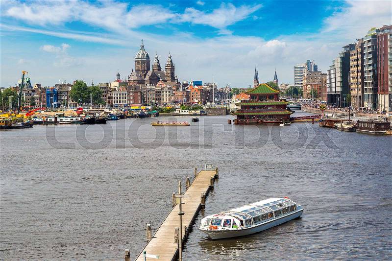 Canal and St. Nicolas Church in Amsterdam in a beautiful summer day, The Netherlands, stock photo