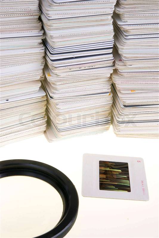 A Pile of Mounted Slide Film Sitting on The Lightbox with Loupe, stock photo