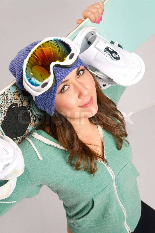 Snowboard and Fun Loving Smiling Female in Teal with all her gear, stock photo