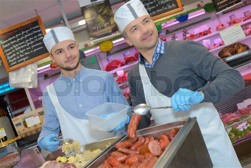 Caterers serving sauerkraut, stock photo