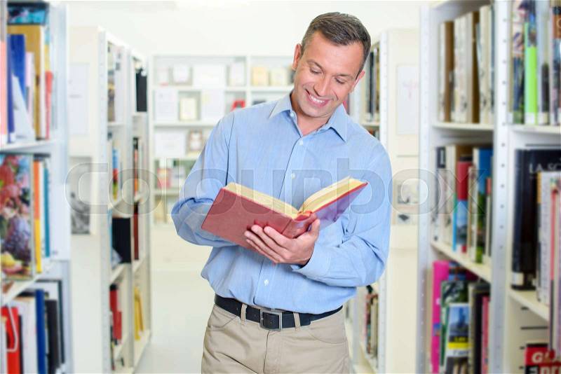 Reading a book while standing up, stock photo