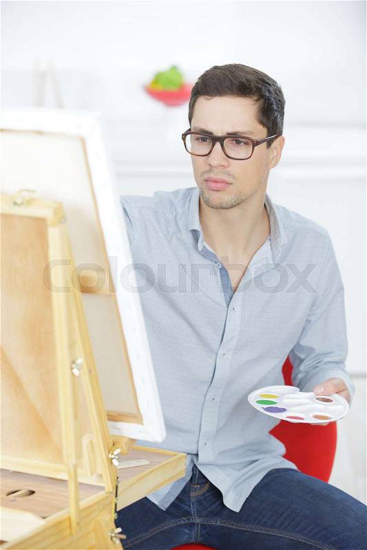 Portrait of a young male artist at work, stock photo