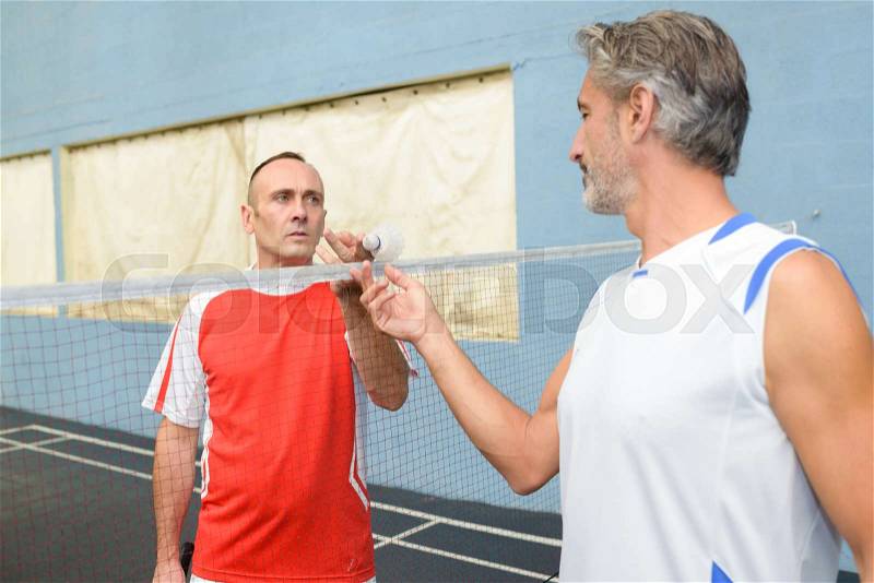 Badminton players on the court, stock photo