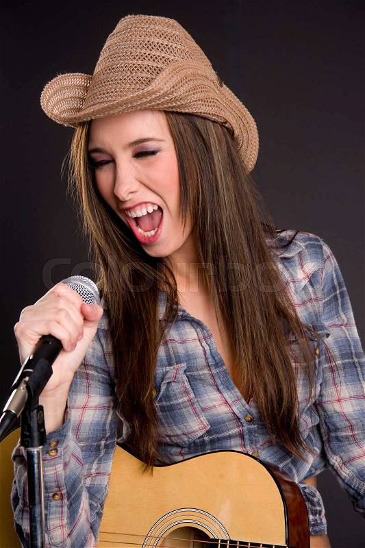 Cowgirl Singer Belts out Tune Yelling Singing into Microphone, stock photo