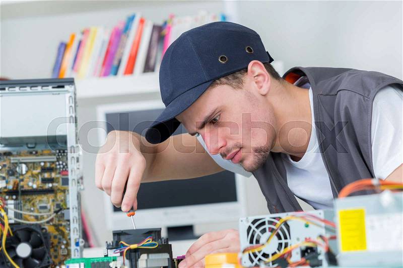 Young male tech tests electronic equipment, stock photo