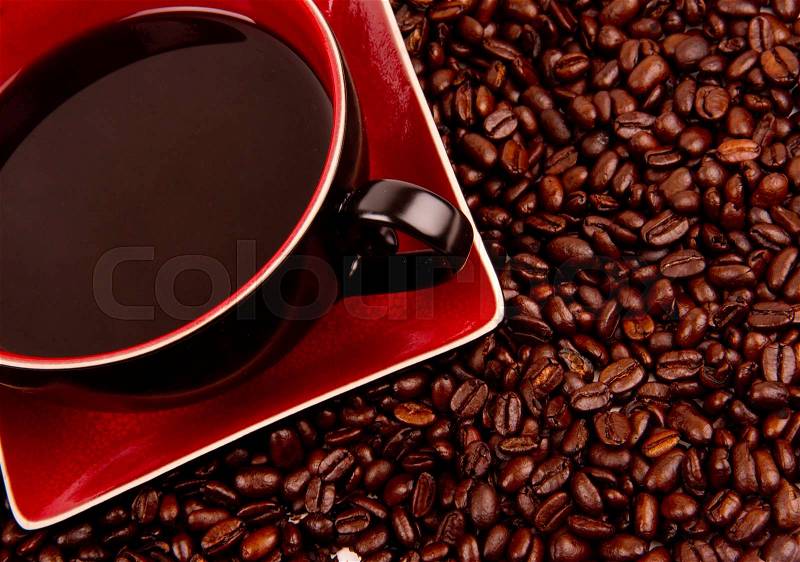 Java in Cup and Saucer Sitting in Coffee Beans, stock photo