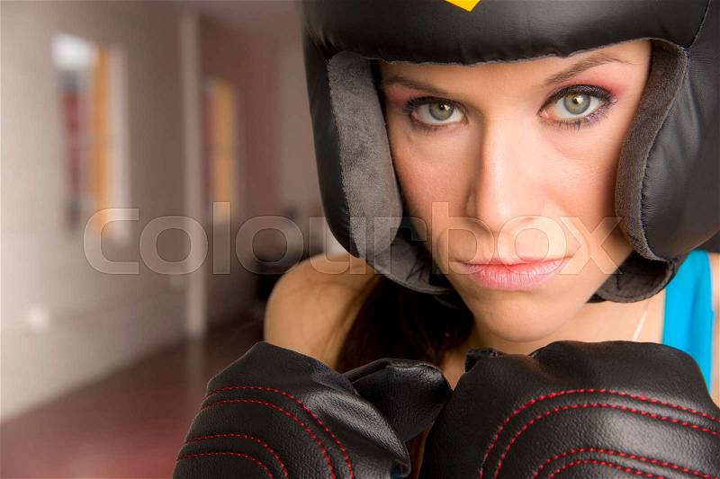 Serious Female Boxer Looks Right at Camera in Close up, stock photo