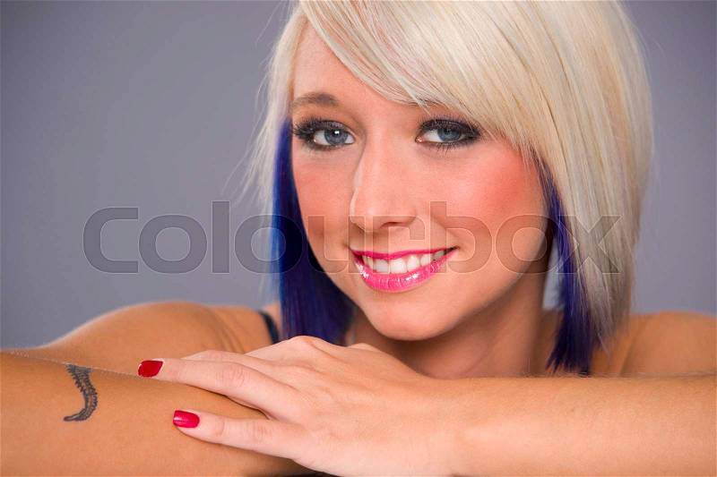 Shining Blonde Beauty With Purple Hair Cut in Intimate Portrait, stock photo